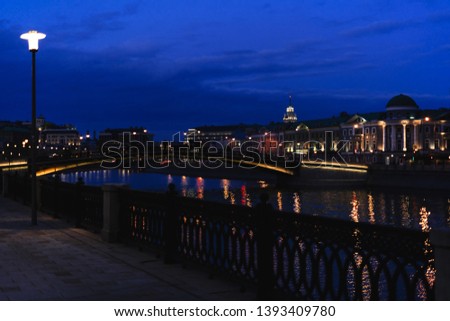 Moscow River embankment at night blue hour with water reflection, Moscow, Russia.