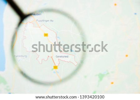 Geretsried city in Germany, Bavaria visualization illustrative concept on display screen through magnifying glass