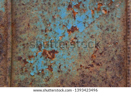 Photo of a metallic rusty blue background with rods