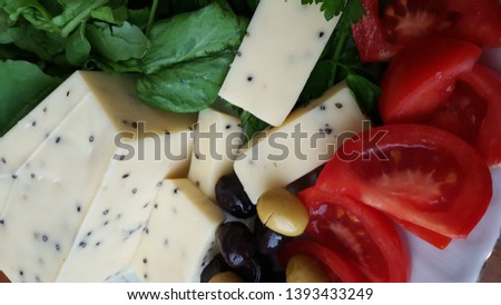 breakfast plate consisting of olives cheese tomatoes carrots