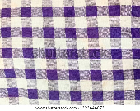 Purple and white checkered texture background.