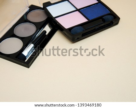 Cosmetics for women ,Makeup brush and decorative cosmetics on a  background,osmetics make up artist objects: lipstick, eye shadows, eyeliner. 