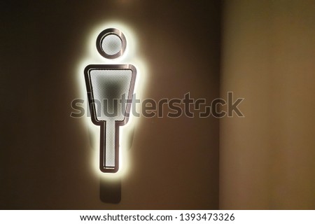 Restroom sign at an entrance of men toilet. Toilet sign with light on classic wall. WC signs for men.