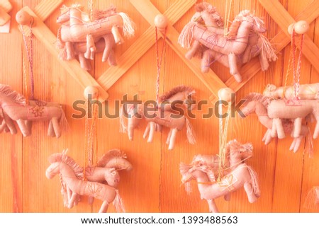 horse hanging key cartoon make by cotton on wall of wooden background