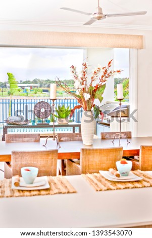 Kitchen tools with ceramic items on dining table, river also forest can see behind fence, colorful photograph from lightning, daytime scene, perfect lights arround.