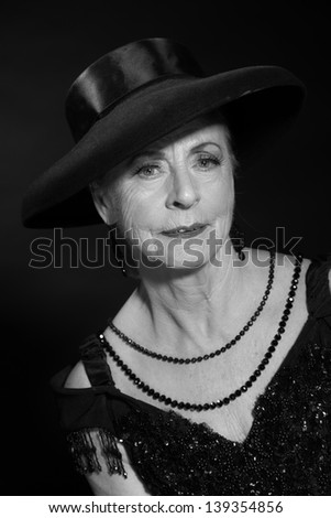 Vintage glamour studio portrait of senior woman. Black and white.