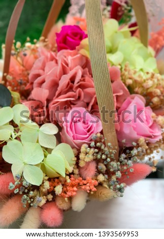 Beautiful romantic fresh bouquet - decorative flower arrangement in a basket. Vertical view