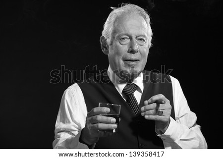 Retro senior business man with whiskey smoking cigar. Black and white photo.