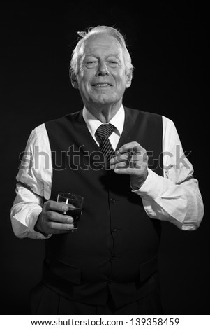 Retro senior business man with whiskey smoking cigar. Black and white photo.