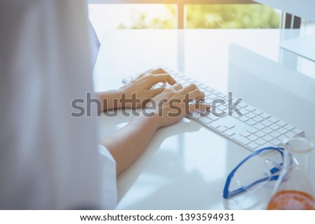 Hands researcher woman using computer keyboard on desk in office room,Fingers typing close up
