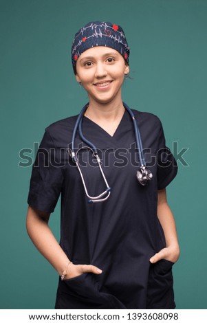 Female doctor smilling on green background. helthcare and medicine concept.