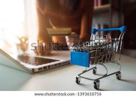Cart Online Shopping concept. businesswoman hand using smart phone, tablet payments and holding credit card online shopping, omni channel, computer virtual icons 
