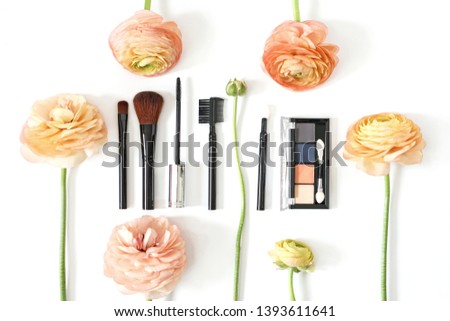 Makeup brush collection eye shadow and ranunculus flowers isolated on white background