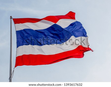 Thai flag blown in the beautiful sky