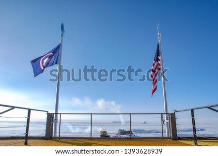 American flag and Antarctica flag with all North directions at Amundsen-Scott South Pole Station in Antarctica