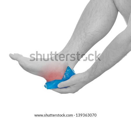 Holding ice gel pack on knee. Medical concept photo. Isolation on a white background.