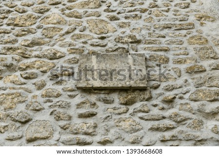 stone wall with a sign