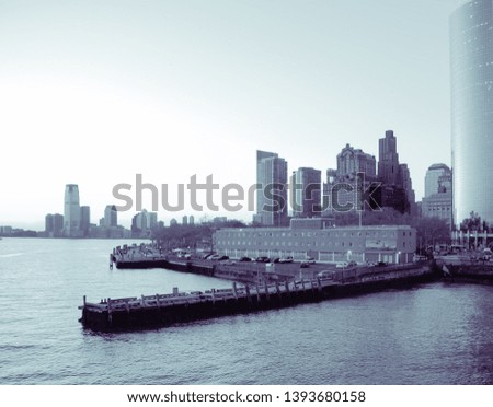 Panoramic view of lower Manhattan skyline from Staten Island, in New York, USA. Blue black and white image