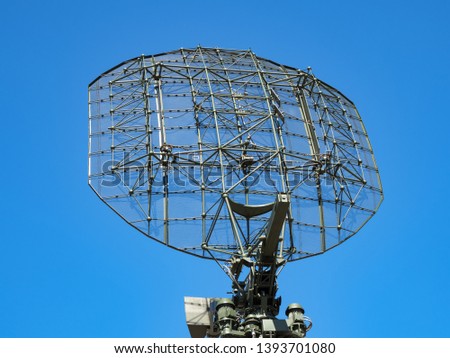 Military directional antenna on a blue sky background.