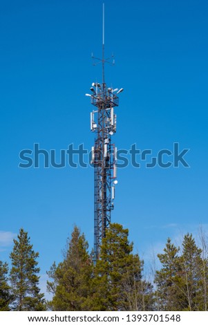 Tower of communication against the blue sky.