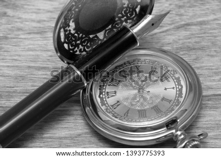 Beautiful fountain pen and pocket watch close-up