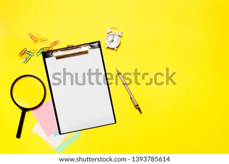 Paper blank with office supplies on a yellow background. Concept of new job, hiring recruitment process, new team members screening.