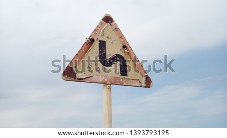 A shooted sign on the road