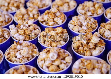 Many cups of popcorn before the movie. Side view, selective focus