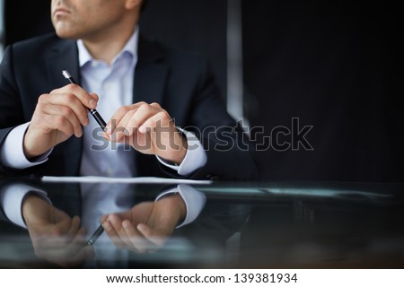 Close-up of male hands with pen Royalty-Free Stock Photo #139381934
