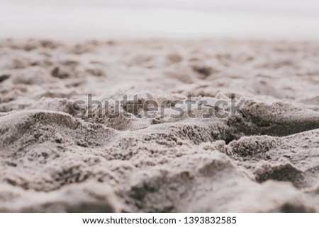 Close up picture of sand on a beach, sunset light