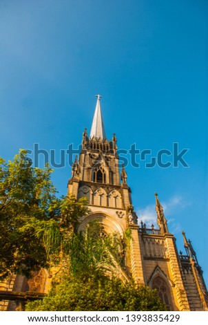 PETROPOLIS, RIO DE JANEIRO, BRAZIL: Cathedral of Petropolis. Church of St Peter. Neogothic. Catholic Cathedral and palm trees on blue sky background
