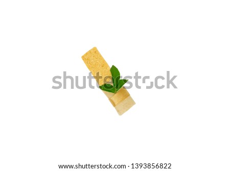Soybean snack bar decored by paper ribbon and organic leaf on white background.