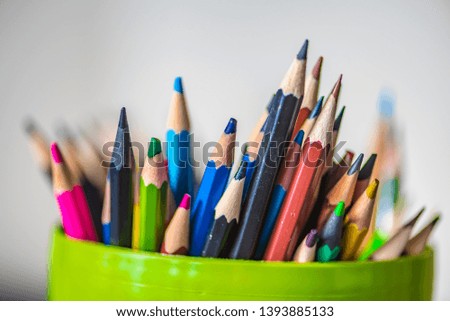 Multicolored pensils in the green box