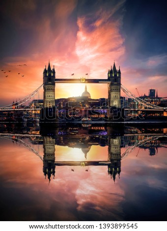 Dreamy view to the Tower Bridge of London, UK, during sunset time with reflections in the river water of the Thames