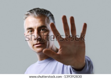 Portrait of casual man  gesturing stop