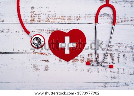 International Nurses day. Red heart with Stethoscope on wooden table background