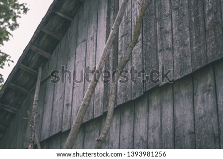 old wooden barn details in countryside at summer with old planks and metal details - vintage retro film look