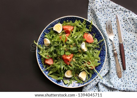 summer salad with tomatoes in white plate on wood table. Food photography. Flat lay concept. Copy space.