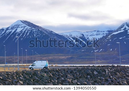 Beautiful scenery of Icelandic snow mountain with the truck on the shore in winter of Iceland 