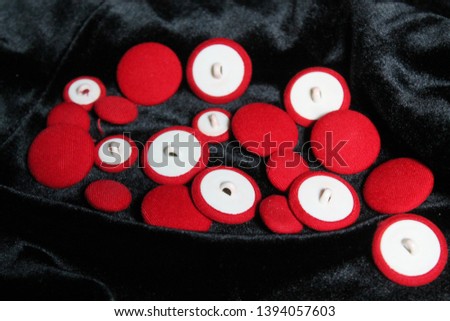 red soft velvet buttons on black shine material 