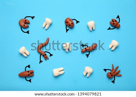 Baby teeth and scary cartoon caries concept. Prevention of oral cavity. Baby dental treatment.