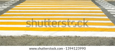 yellow white pedestrian crossing on the city road