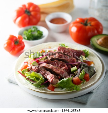 Beef steak tortilla with avocado and tomato