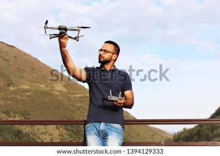 Young man holding drone before flight outdoor