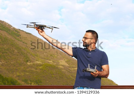 Young man holding drone before flight outdoor