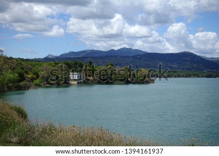 Photo of famous lake and dam of Marathon or Marathonas with beautiful clouds and blue sky, North Attica, Greece