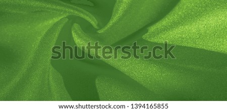 Texture, background, pattern, silk green fabric. Crepe satin on the back is an excellent fabric for design, on the one hand it has a satin finish, and on the other - crepe, which makes it reversible,