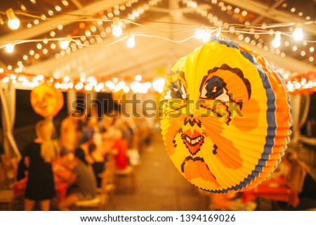 Swedes love to use brightly colored lanterns for decorations during their crayfish parties, which typically take place in the end of August. The main lantern is usually of a smiling yellow moon. Royalty-Free Stock Photo #1394169026