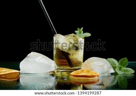 Chilled alcoholic cocktail with ice and boiler tube