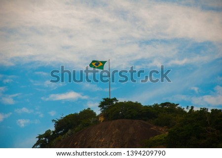 Rio de Janeiro, Lama beach, Brazil: Beautiful landscape with mountain and beach. Flag of Brazil on the mountain.